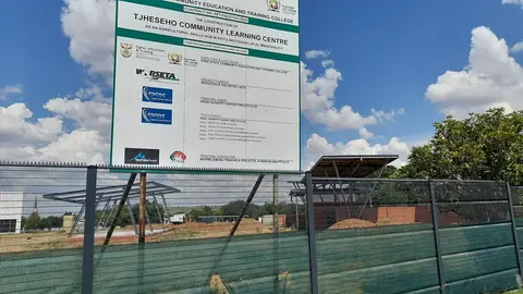 Unfinished community skills development centre with its project board