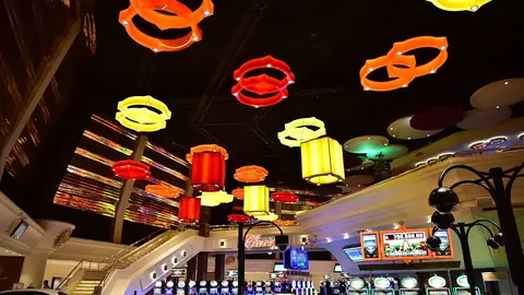 Gaming floor with slot machines under lantern lights at Sun City casino